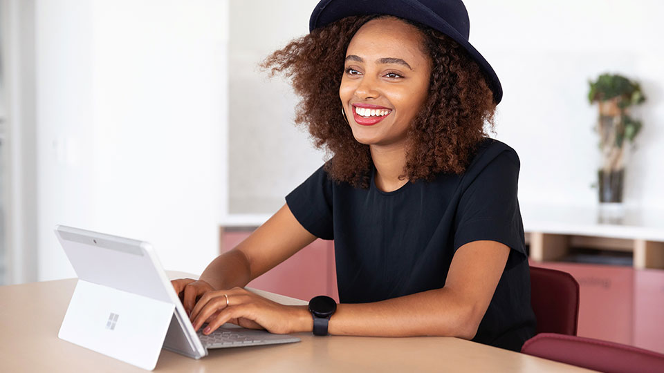 A smiling woman with a laptop