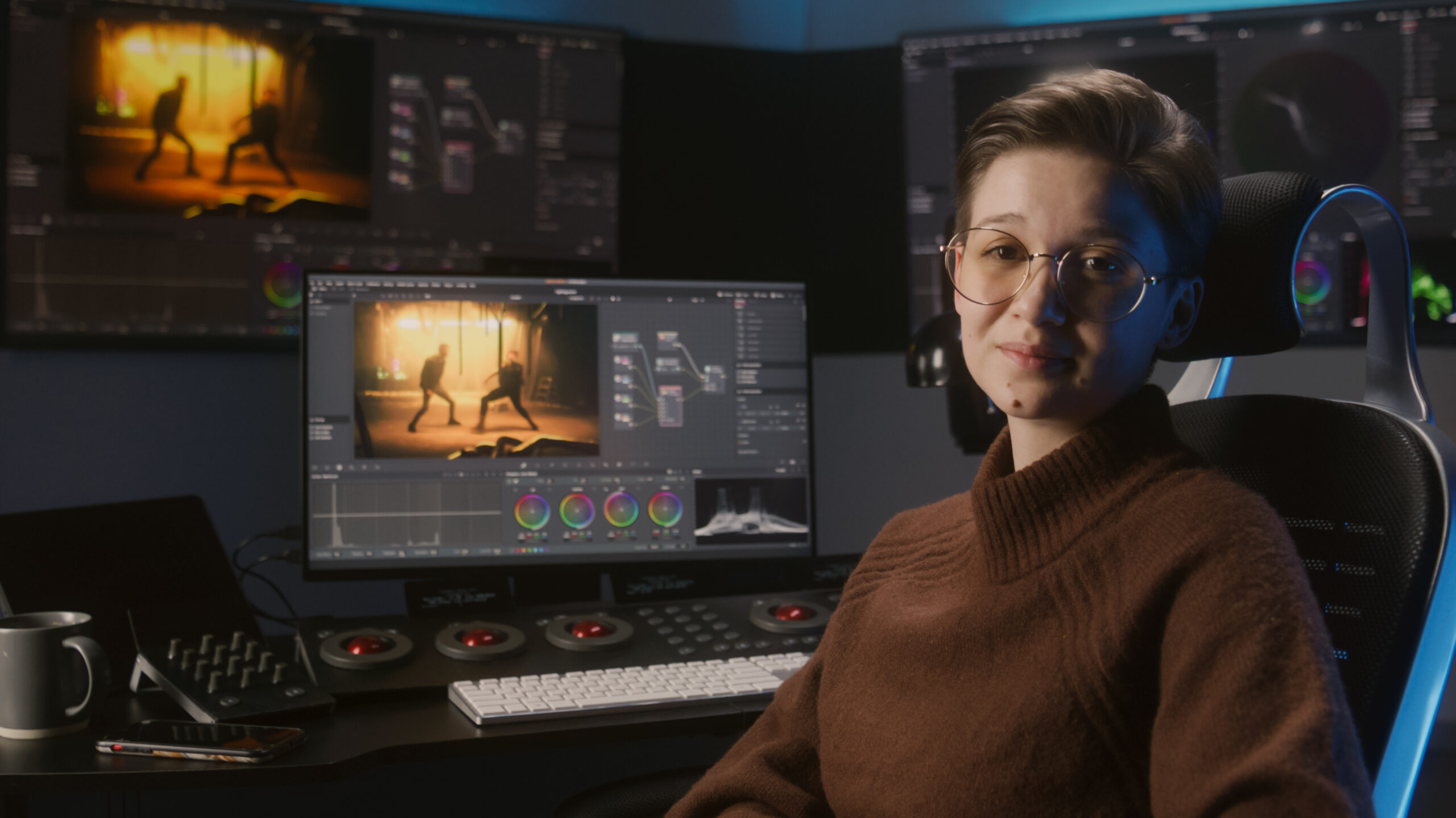 Woman sitting at a video editing station