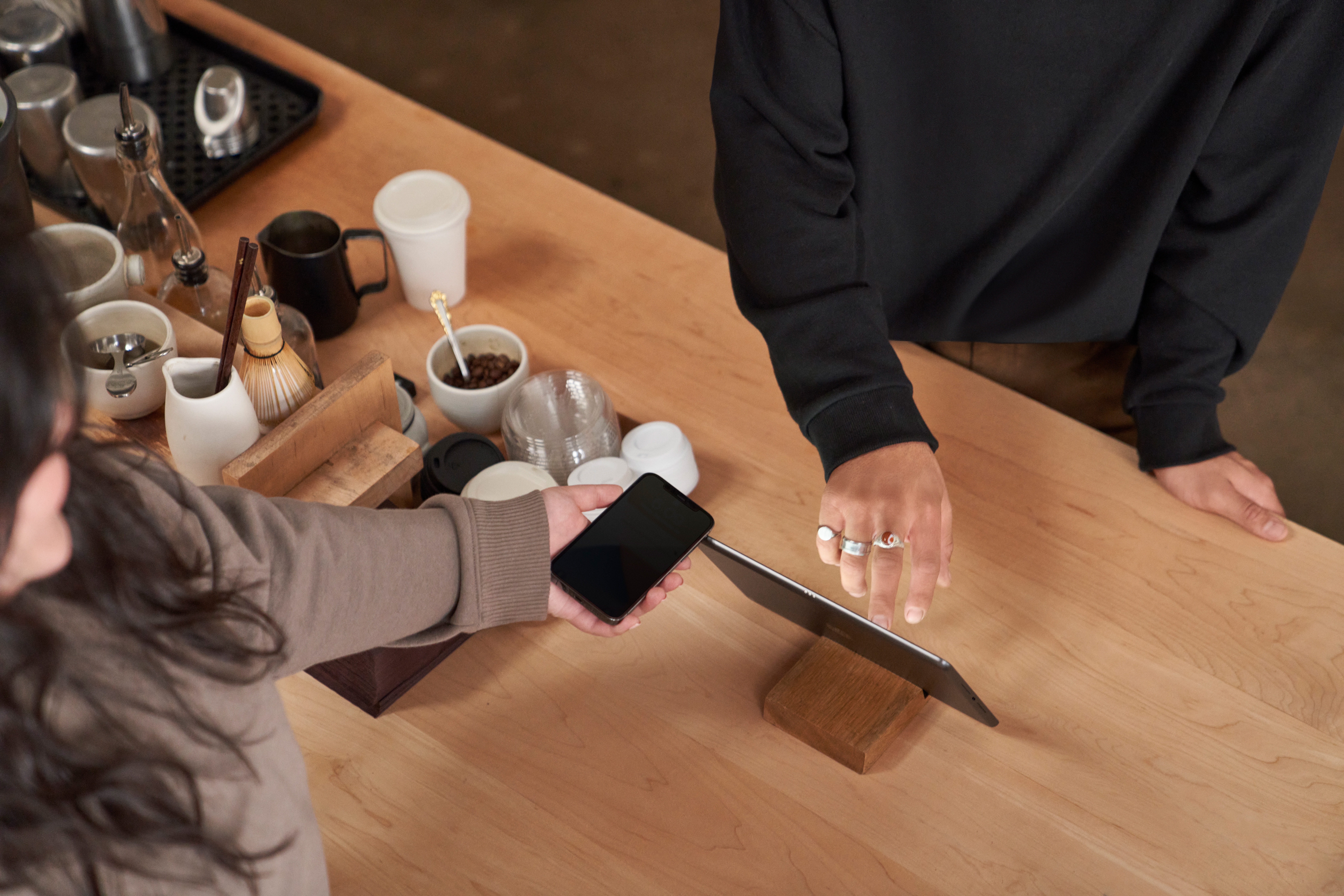 an image of a customer paying for a product using the digital wallet on their phone